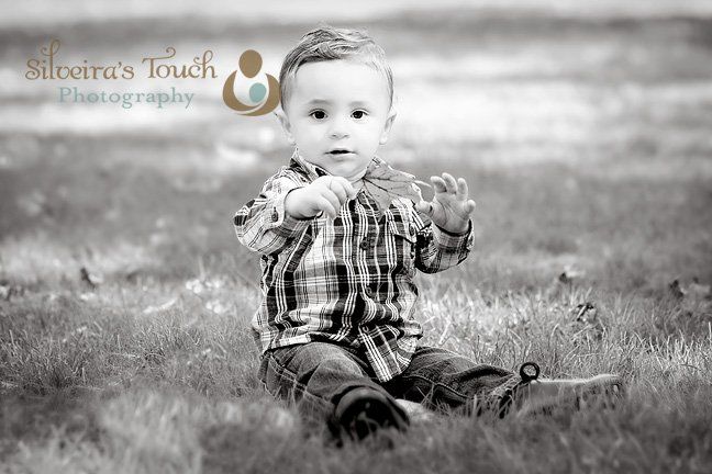 Photo of firast birthday boy holding leaf 