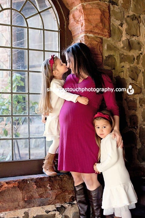pregnancy mom with twin daughters snuggling