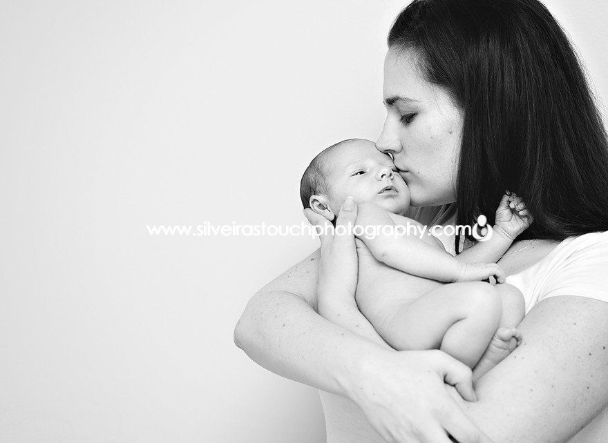 mom and newborn pictured kissing 