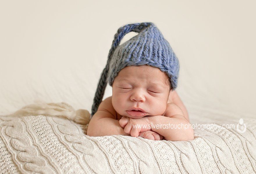 newborn baby sleeeping hands on chin