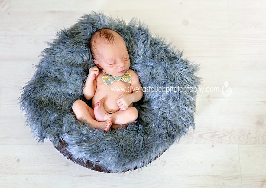 clark nj newborn photographer of sleepy boy on blue rug in basket