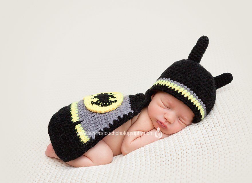 newborn photography of baby wearing batman costume