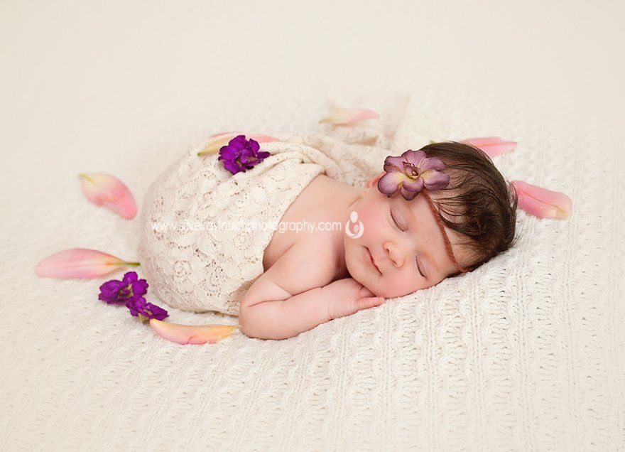 Newborn photography of baby girl sleeping with flowers in VErona NJ