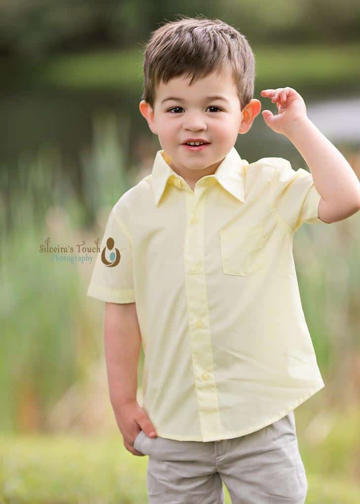 Third birthday portraits taken at park in Denville NJ birthday boy happy