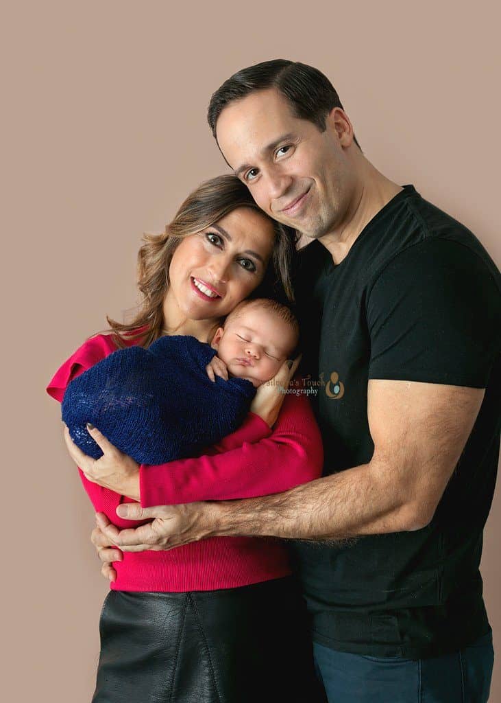 Mount Olive NJ infant photographer of family holding new baby boy in a blue wrap