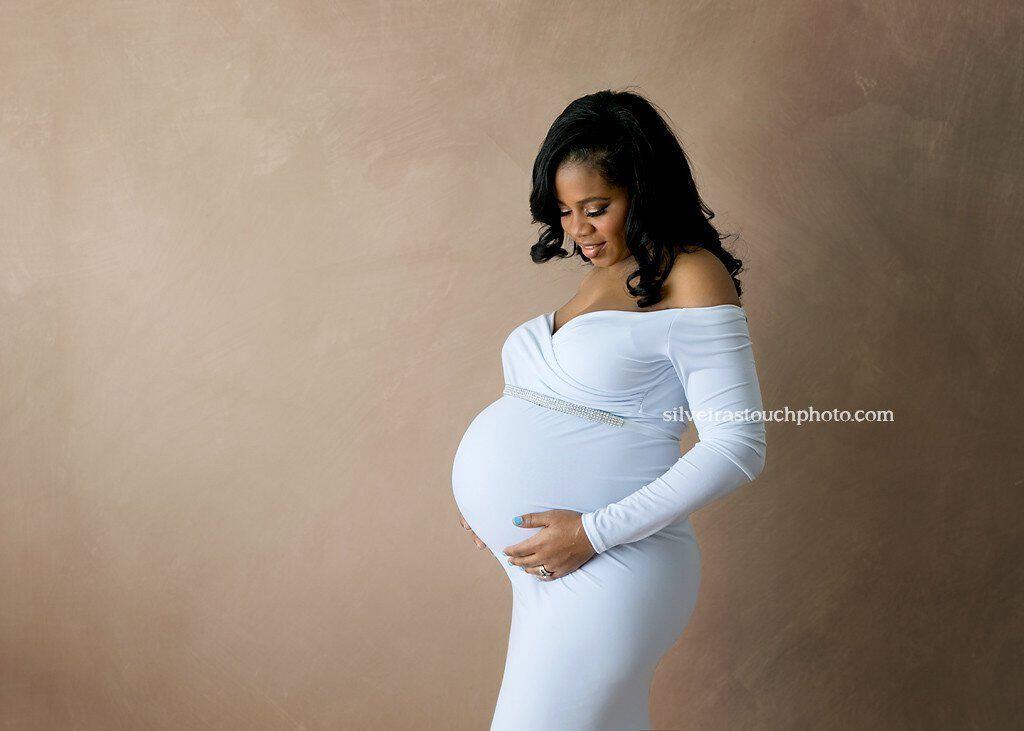 baby bump photography randolph nj captured in studio of her wearing a white maternity gown