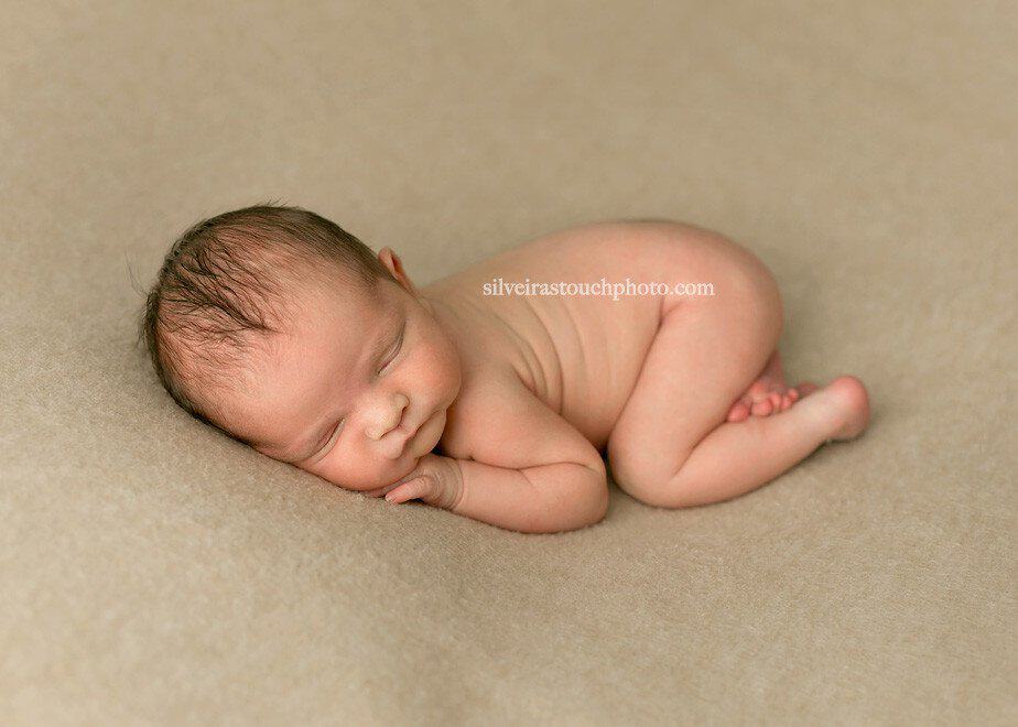 newborn baby photography of little boy laying on blanket sleeping