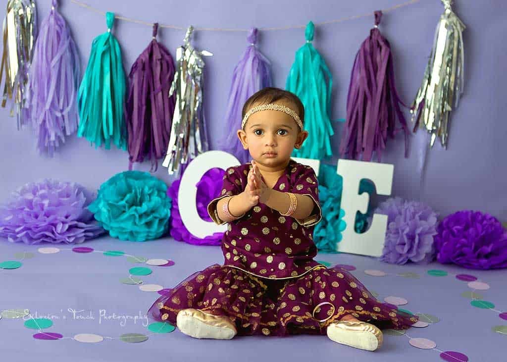 first birthday photo of baby wearing indian ethnic outfit