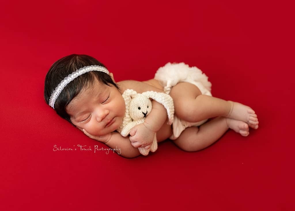 baby photography session with stuffed bunny