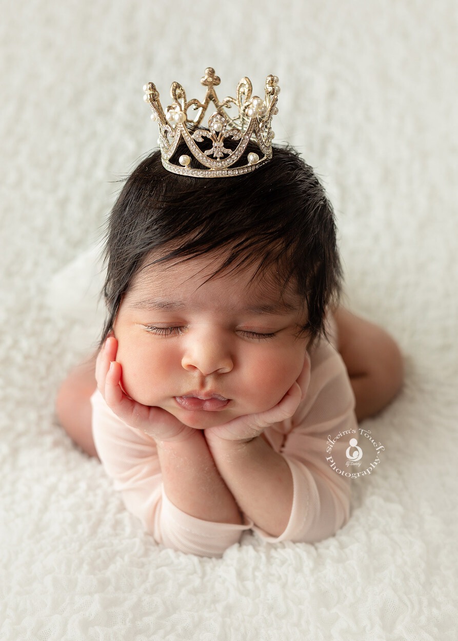 newborn girl wearing crown photo