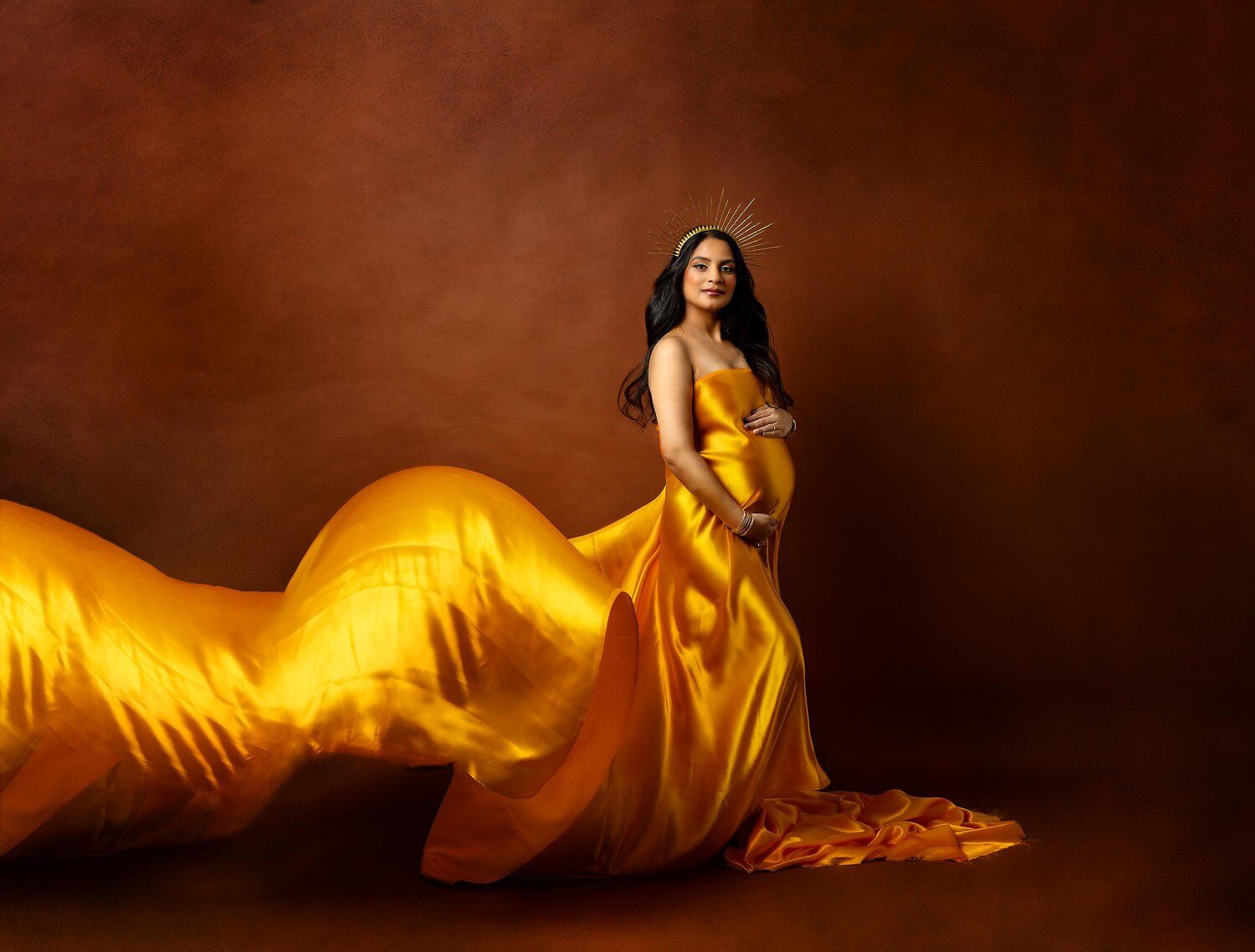 new jersey maternity photo of mom to be wearing a gold flowing fabric
