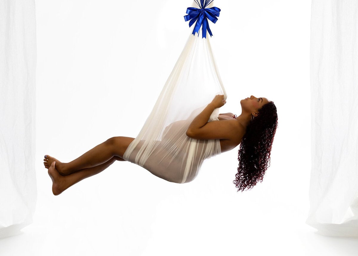 hanging maternity photoshoot with white fabric